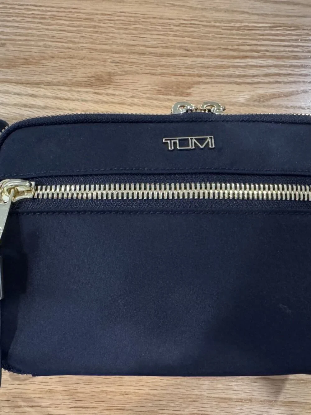 Authentic TUMI Voyageur Langley Crossbody in black with gold-tone hardware